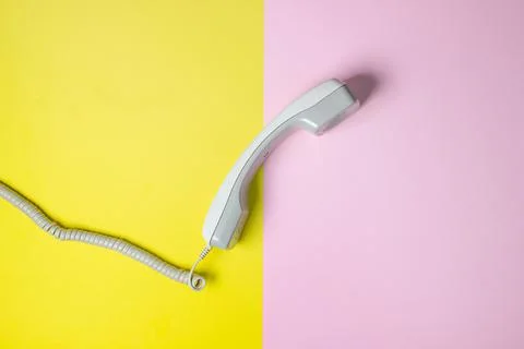 Telephone receiver on a geometric background. Colored background.  Stock Photos