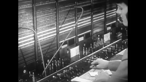 A telephone switchboard operator uses the cord signal called the recall in 1949. Stock Footage