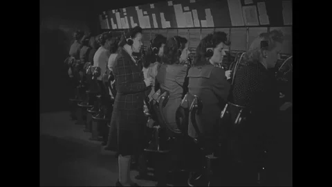 Telephone switchboard operators at work in office - 1945 Stock Footage