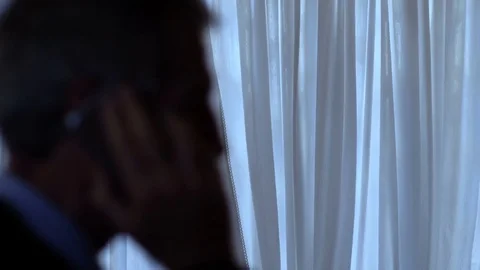 Telephone Tapping: man talking on the phone in twilight Stock Footage 80892159