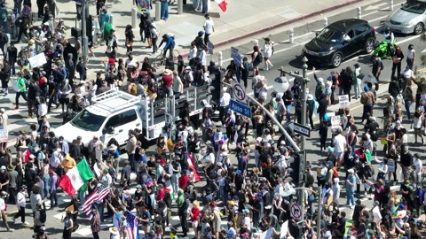 Telephoto drone shot of ICE riots, blocking the streets of Los Angeles, USA Stock Footage 311176953