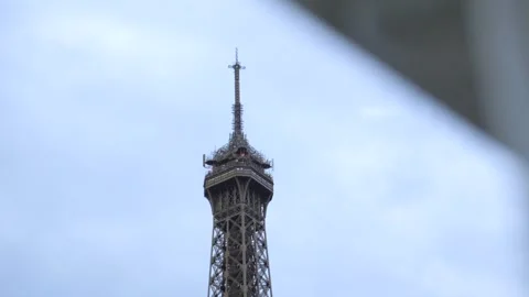 Telephoto Slow Motion Shot of Eiffel Tower Top Floor Under Overcast Sky Stock Footage 320663525