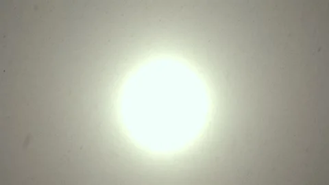Telephoto of sun shining through clouds during blizzard Stock Footage 331762393