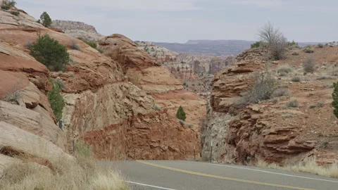 Telephoto view of beautiful Escalante red rock countryside, road in foreground Stock Footage 248582853