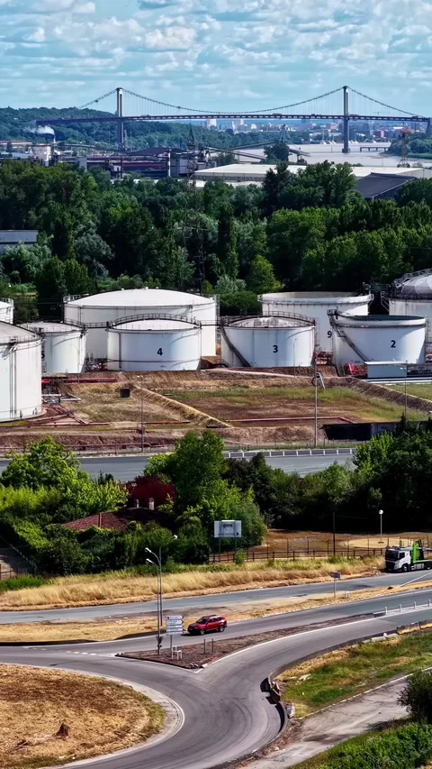Telephoto view of bulk storage tanks at the Port of Bordeaux with the Pont Stock Footage 346579651