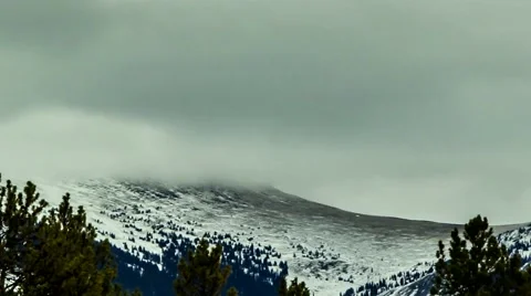 Telephoto view of mountain below gray clouds in timelapse 스톡 동영상 45114416