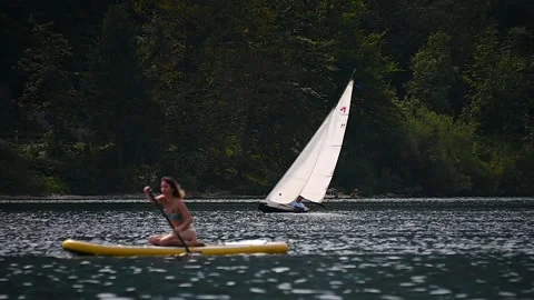 Telephoto view of small train sailing yacht boat float in Bohinj lake, Slovenia Stock Footage 170649256