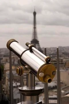 Telescope with eiffel tower Stock Photos
