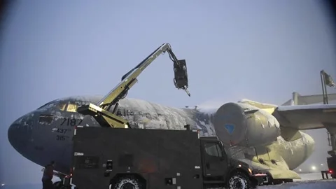 Telescopic boom deicing C-17 Globemaster III at Joint Base Elemendorf-Richardson Stock Footage 227138060