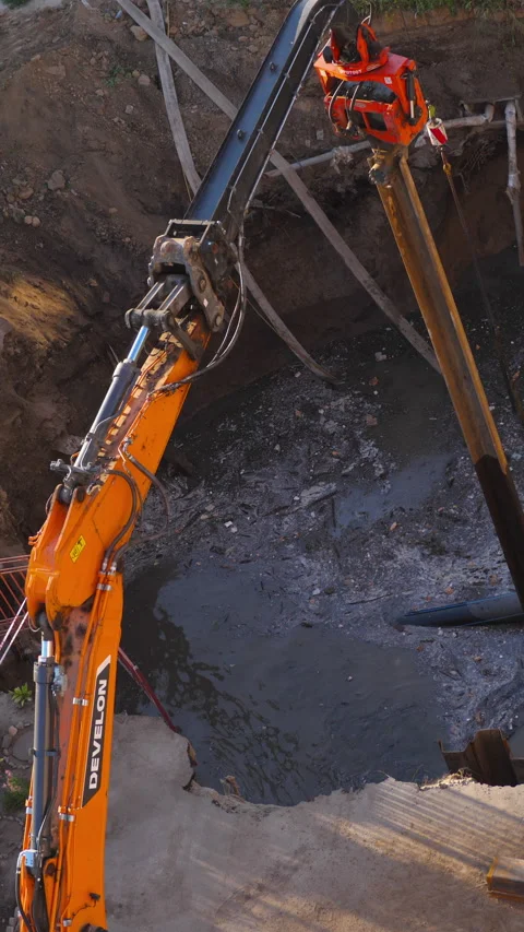 Telescopic excavator repairing sewer collector pit in Novosibirsk Stock Footage 345001663