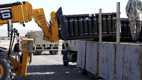 Telescopic handler loading crate of ammunition onto truck at Al Asad Air Base Stock Footage 168740805