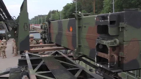 Telescopic handler loading patriot missile onto trailer Stock Footage 90120752