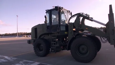 Telescopic handler pulling machinery on airstrip Stock Footage 84683332