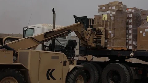 Telescopic handler unloading pallets from truck Stock Footage 87826246
