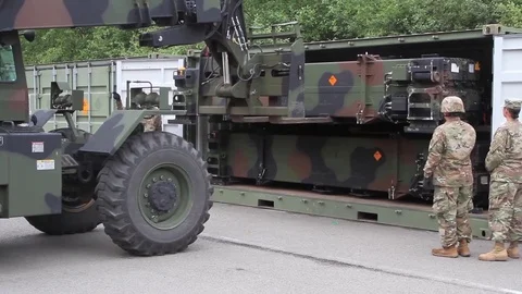 Telescopic handler unloading patriot missile from container Stock Footage 90120741
