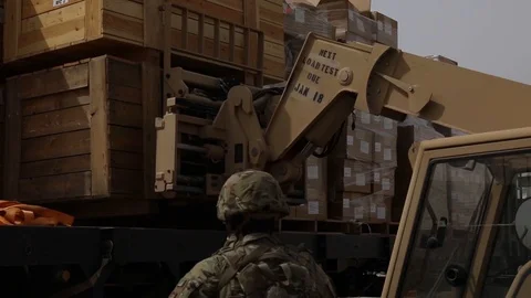 Telescopic handler unloading wooden crates Stock Footage 87826091