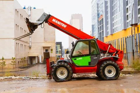 Telescopic loader handler. Red Manitou telehandler at construction site Stock Photos