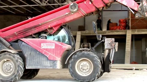 Telescopic loader MANITOU on construction site. Stacking building materials. Stock Footage 152474012