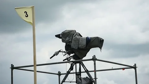 Television broadcast camera setup on a tripod and protected by a rain cover 스톡 동영상 108934629