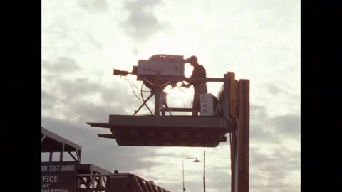 Television camera crew filming Gemini space rocket launch from raised platform Stock Footage 263445498
