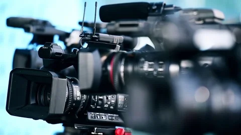 Television cameras in a row broadcasting a live media event Stock Footage 73684292