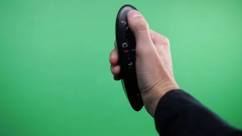 Television Remote Changing Channels On Green Screen. Hand using a remote control Stock Footage 102826069