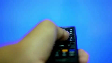 Television remote control close-up. Change channels on the TV using remote .. Stock-Footage 257873570