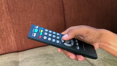 A television remote control is held in a man’s hand Stock Footage 232175745