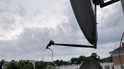 Television satellite dish on the background of a cloudy sky.  Stock Footage 201307831