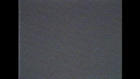 A television screen with VHS effect of digital pixelated noise, displaying a 4x3 Stock Footage 258116164
