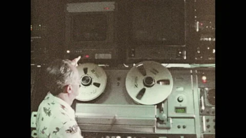 Television station, film reels spin, footage appears on screens. Channel 2 10pm Stock Footage 135206004