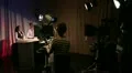 Television studio on air with presenters, cameras, lights and camera operators HD Footage