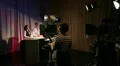 Television studio on air with presenters, cameras, lights and camera operators HD Footage