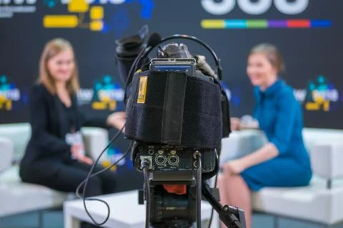 Television video camera recording interview in broadcast news studio Fotos de archivo