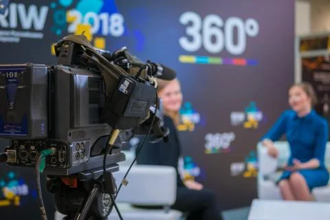 Television video camera recording interview in broadcast news studio Fotos de archivo
