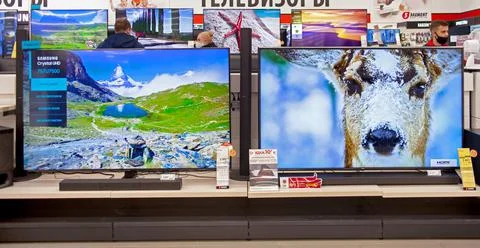 Televisions of different brands in the electronics store Stock Photos