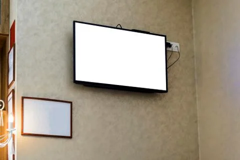 Televisor on a wall with a blank frame for your advertising. Stock Photos