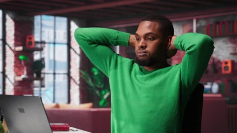 Teleworker fixing his back posture and suffering a muscle cramp at home desk Stock Footage 307724066