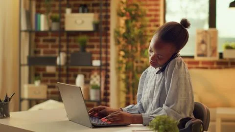 Teleworker take phone call while working Stock Photos