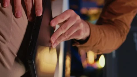 Teleworker unpacking backpack, writing lines of code on laptop Stock Footage 265108923