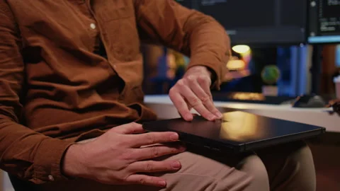 Teleworker unpacking backpack, writing lines of code on laptop Stock Footage 265512448