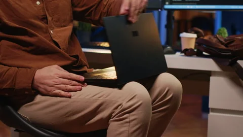 Teleworker unpacking backpack, writing lines of code on laptop Stock Footage 265621189