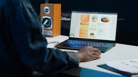 Teleworker using accounting statistics graphs for project research Stock Photos