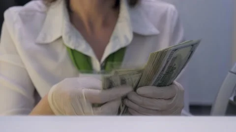 Teller Counting Dollars in Protective Gloves. Bank Employee Recounts Cash in One Stock Footage 141011093