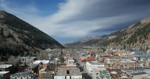 Telluride downtown and river medium to high aerial backward motion Stock Footage