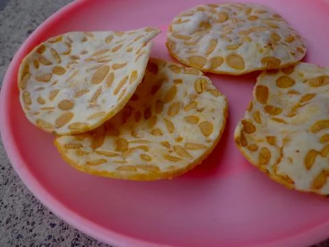 Tempe chips made from thin slices of fried tempeh Stock Photos