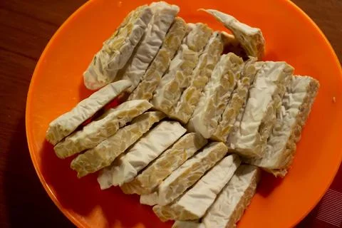 Tempeh in a plastic container Stock Photos