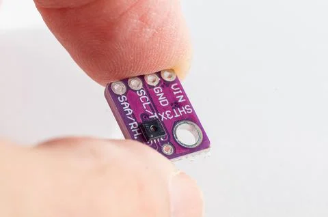 Temperature and pressure sensor for a DIY smart home held in hand Stock Photos