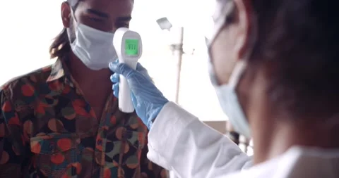 Temperature check and hand sanitization on welcome Stock Footage 145119227