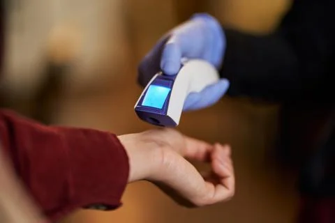 Temperature check before letting s into the facility Stock Photos